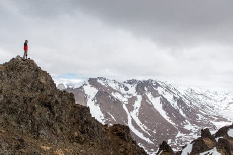 Hiker views a mountain range in Alaska.