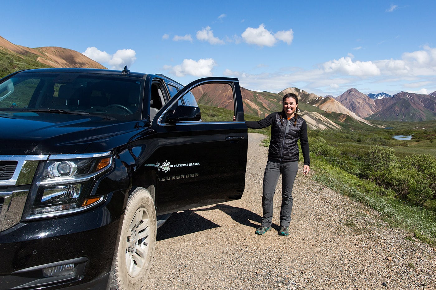 woman next to a traverse Alaska car